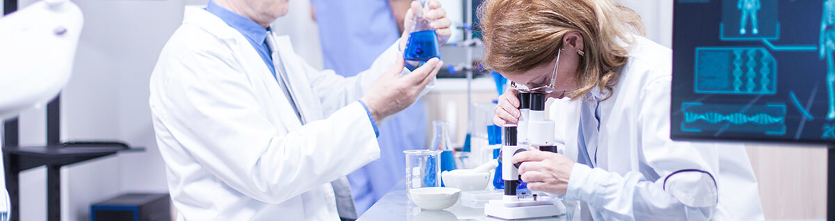 Groupe of researchers in pharmacology in a hospital laboratory. Modern equipment in research laboratory.